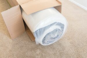 Close up top view roll packed spring mattress on carpeted floor