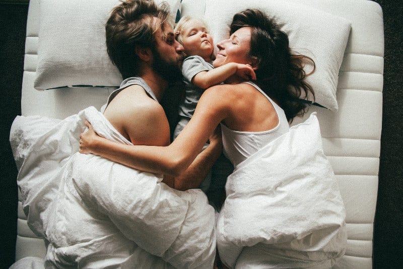 Family sleeping on special mattress for adjustable bed