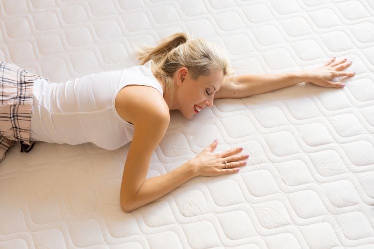 Woman Enjoying New Comfortable Mattress