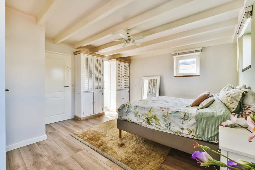 a bedroom with a bed and a ceiling fan